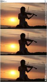 美女夕阳海边拉小提琴