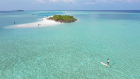 一个人在木板上划船去一个小岛