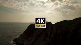 航拍夕阳下海边悬崖上的灯塔