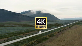 航拍远山乡道上行驶的汽车